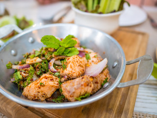 Thai food fusion style, spicy minced salmon salad (Larb Salmon),Close up Thai local traditional Isaan Northest.