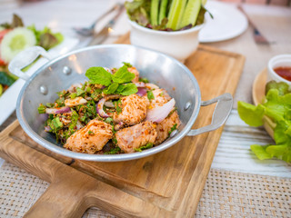 Thai food fusion style, spicy minced salmon salad (Larb Salmon),Close up Thai local traditional Isaan Northest.