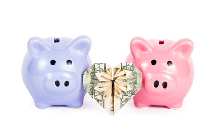 Two piggy banks on white background. Heart of origami from the dollar. Valentine's heart. Dollar heart shape on white background