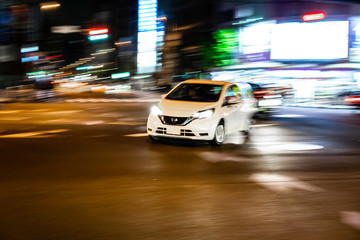 Fototapeta premium Car fast speed drive on asphalt road at night (Ueno area, Tokyo, Japan)