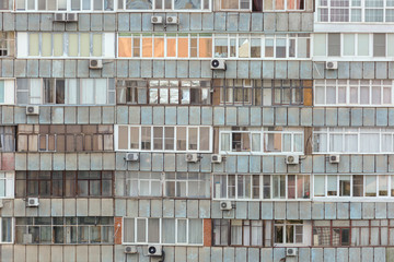 Background of old apartment building with a lot of windows and air conditioners.