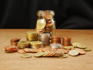 concept saving money,coins in a jar