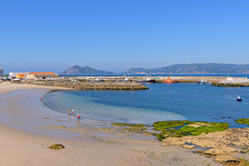 Beach and fishing harbor in Porto do Son, Galicia, Spain.