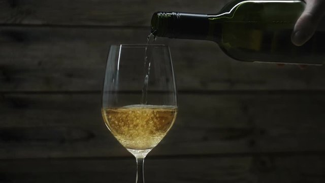 White wine pouring into a wine glass. Seamless cinemagraph video
