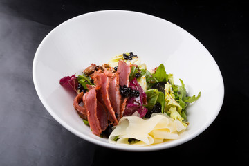Elegant duck meat salad with caviar