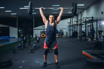 Strong powerlifter doing deadlift a barbell in gym