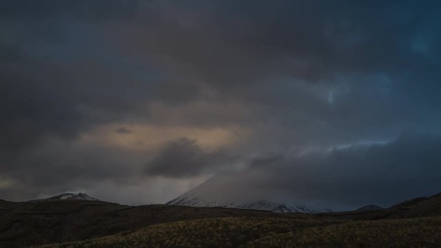 Clouds flying over volcano Mount Doom in the evening in Tongariro National Park, New Zealand. Timelapse video.