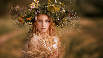 Girl in a field with flowers in their hands