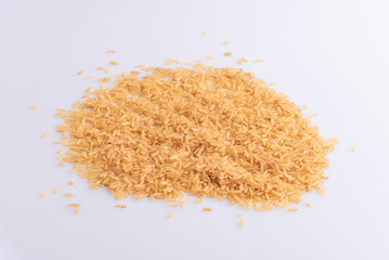 Raw Brown Rice on white background. Integral Wholegrain. Latin term Oryza sativa also known as Whole Chinese Rice seed