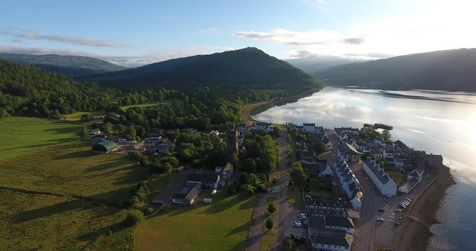 Scottish Hill Aerial Drone Pulling Back over Morning Countryside and Village - Inveraray Castle