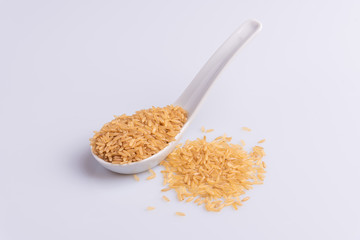 Raw Brown Rice on white background. Integral Wholegrain. Latin term Oryza sativa also known as Whole Chinese Rice seed