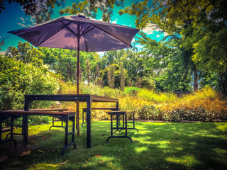 Garden furniture in shadow of backyard in vintage colors