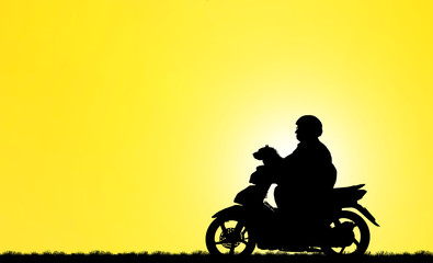 Fototapeta na wymiar silhouette Man motorbike and dog on blurry sunrise background.