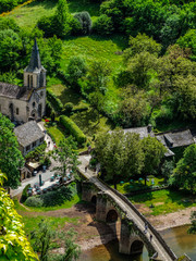 Fototapeta na wymiar Belcastel medieval village, with church and bridge over the Aveyron river, Aveyron, France