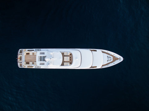 Top-down view of white luxury motor yacht in ocean