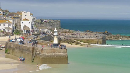Tourists visiting Smeaton's Pier in St Ives, Cornwall, on a very hot, summer day in June 2018.