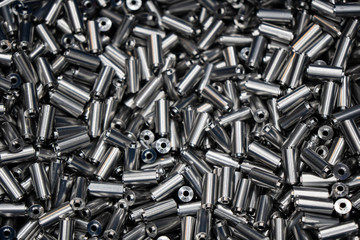 The pile of machined metal rod in the tray.Parts machine manufacturing process.