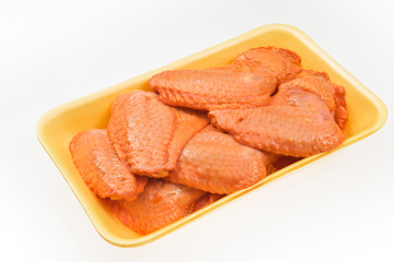 Fresh chicken wings with sauce in package