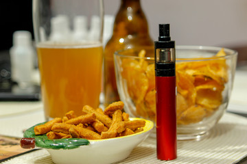 Electronic cigarette on club table in the living room.  Usually layout with electronic cigarettes and little things. Advanced model of electronic cigarette, e-cig mod or personal vaporizer.