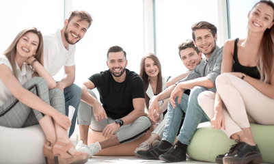 group of successful young people sitting in a new office