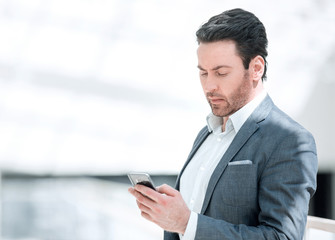 Fototapeta na wymiar close up.businessman reading text message on smartphone