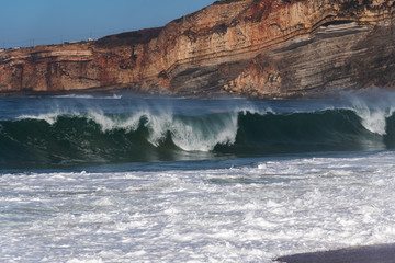 Spashing Atlantic ocean waves in Nazare, Portugal.