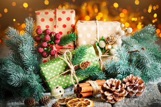 Merry Christmas and happy New year. Christmas gift and Christmas tree on dark wooden background. Selective focus.