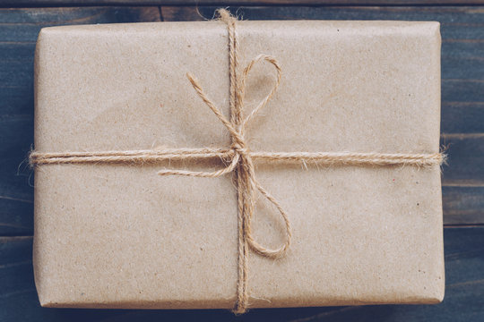String Or Twine Tied In A Bow On Kraft Paper Gift Box Texture