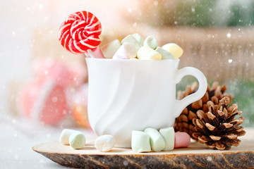 Merry Christmas and happy New year. Cup of cocoa and marshmallows on a light background. Background with copy space. Selective focus. Christmas background.