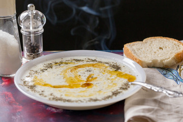 traditional Turkish soup in winter: plateau soup; yogurt, rice, mint with butter and smoke on top