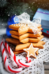Merry Christmas and happy New year. Cookies gifts and fir tree branches on a wooden table. Selective focus. Christmas background.