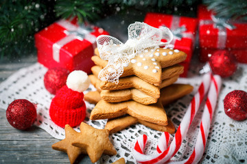 Merry Christmas and happy New year. Cookies gifts and fir tree branches on a wooden table. Selective focus. Christmas background.