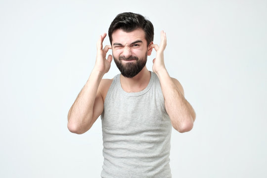 Spanish Young Man Covering His Ears Hands