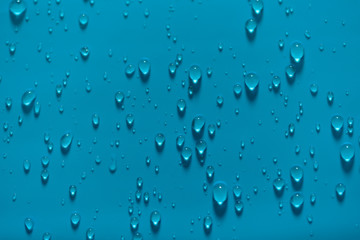 Cyan blue latex with water drops.