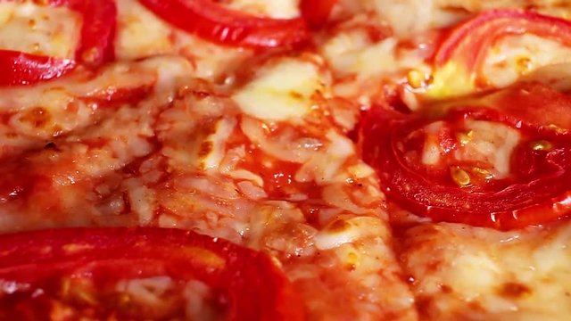 Vegetarian pizza margarita texture closeup on rotating plate