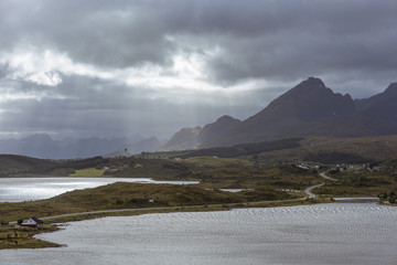 Sunrays in natural mountain landscape with seaview at summer in Lofoten, Norway.