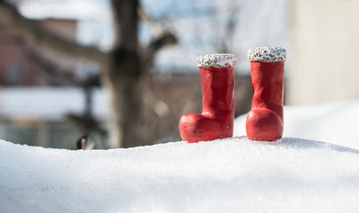 Small red christmas boots on snow