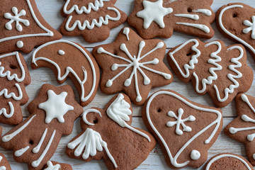 Gingerbread cookies decorated with royal icing on wooden background