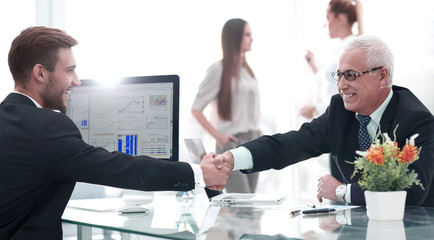 businessman welcomes business partner shaking hands