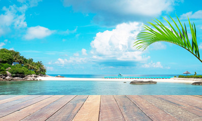 empty wood desk and summer blue sea background and leaf coconut palm tree .Blank space for text and images.Concept Summer, Beach, Sea, Relax, Party. © oatautta