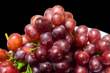 Healthy fruits, Ripe grapes in dish on black background 