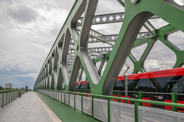 The Old Bridge over the Danube River in Bratislava, Slovakia.A green truss steel bridge , a red...