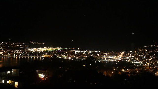 Timelapse video of Wellington Airport at night with landing airplanes.
