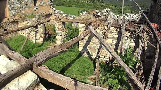 Destroyed houses of the time. Stone walls, surrealistic video background. Abandoned village in Rhodope Mountain, Bulgaria.