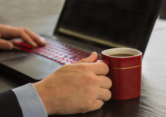 Fototapeta na wymiar Business man working on laptop with cup of cofee