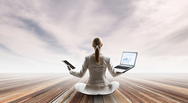 Businesswoman in lotus pose. Mixed media - Powered by Adobe