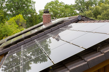 Roof surface of house with black solar panels
