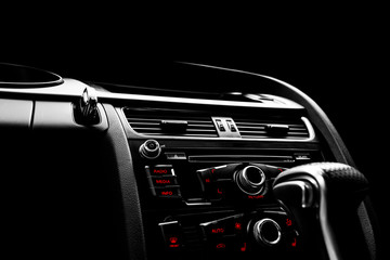 Modern Luxury car inside. Interior of prestige car. Black Leather. Car detailing. Dashboard. Media,...