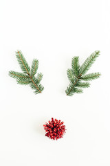 Christmas, New Year minimal concept. Christmas deer symbol made of fir branches and red decoration isolated on white background. Flat lay, top view.