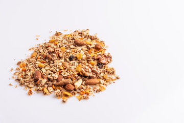 Granola or muesli with nuts and rasins on a white background, angle view, copy space, soft light